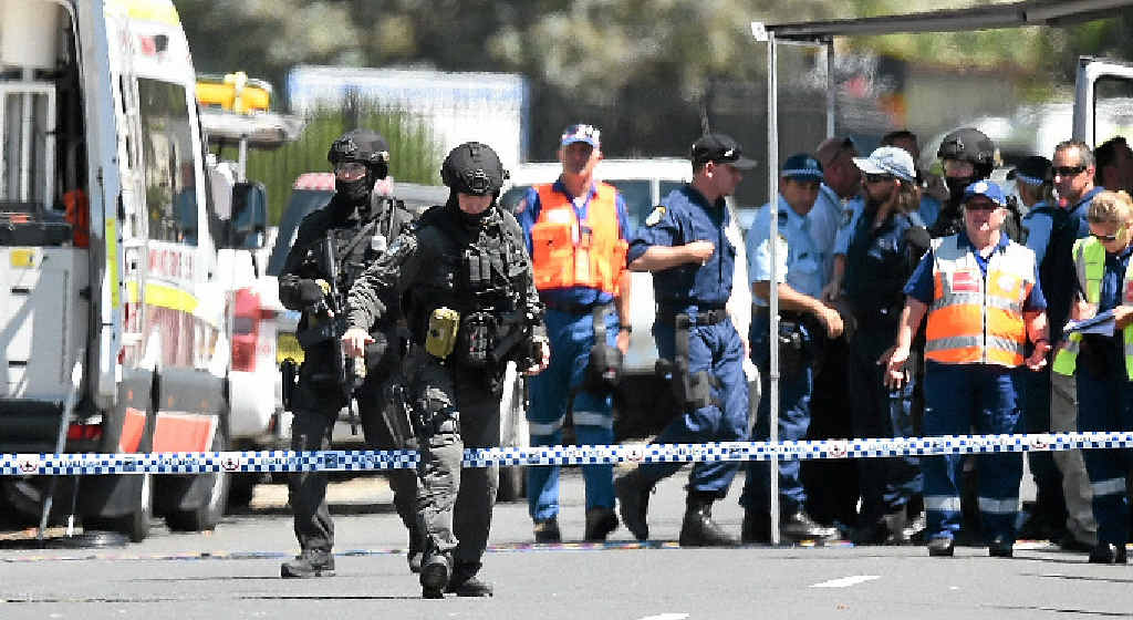 ON HIGH ALERT: Tactical police form a perimeter around a Sydney factory on Monday following the shooting death of a man and wounding of two other people. ON HIGH ALERT: Tactical police form a perimeter around a Sydney factory on Monday following the shooting death of a man and wounding of two other people.