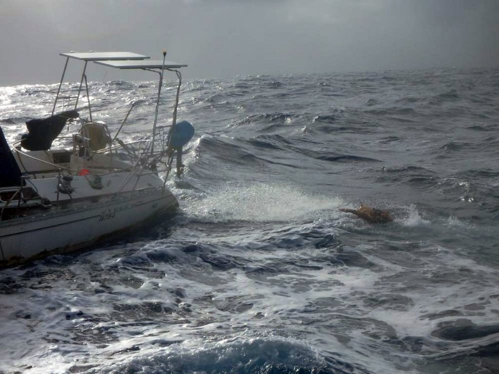 LMAX Exchange crew member in the process of boarding mummy yacht, Sayo, of the coast of Guam. LMAX Exchange crew member in the process of boarding mummy yacht, Sayo, of the coast of Guam.