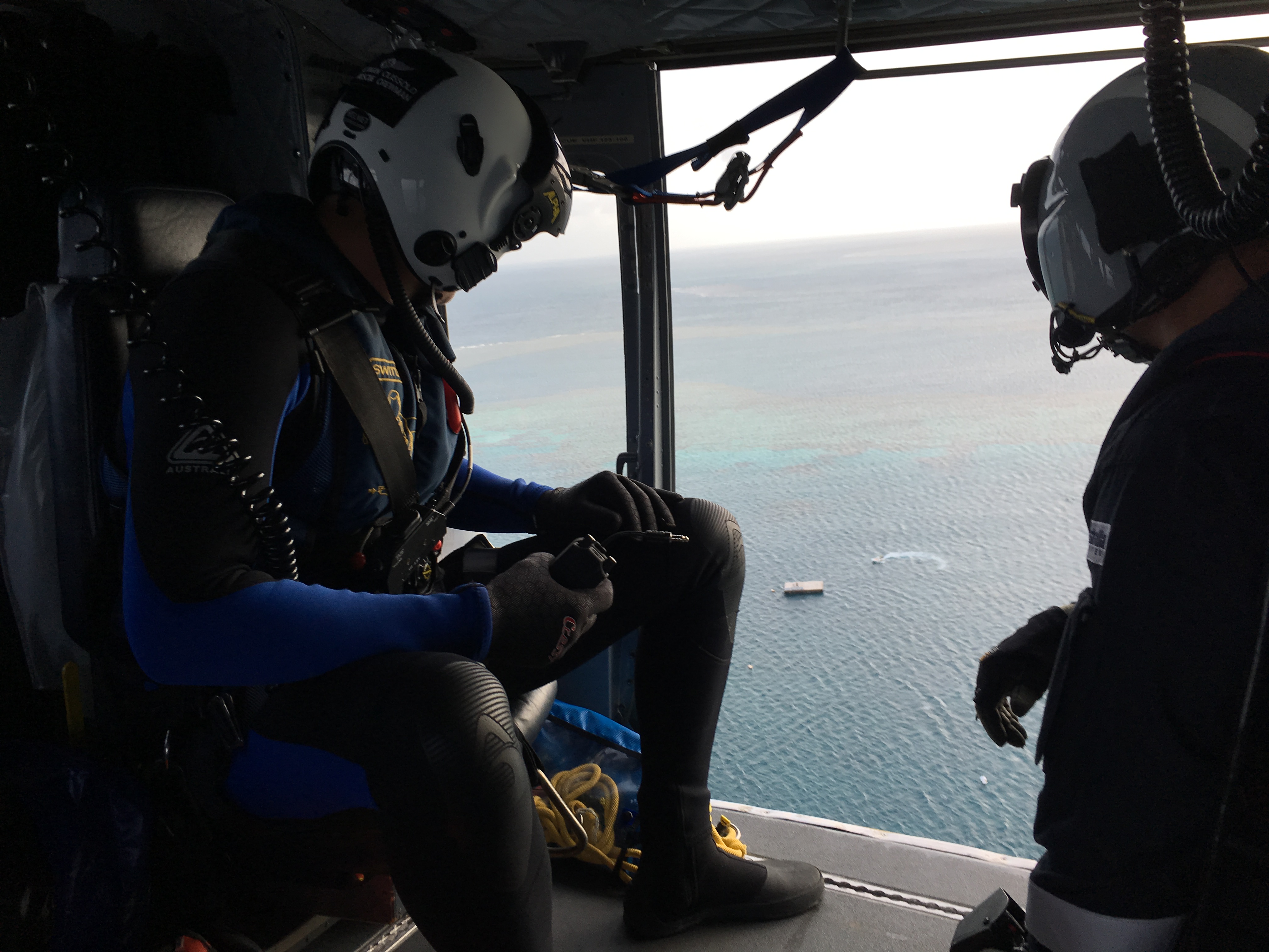 RACQ CQ Rescue approached the pontoon at Knuckle Reef ready to winch down the rescue crewman, left, to assist an injured fisherman. RACQ CQ Rescue approached the pontoon at Knuckle Reef ready to winch down the rescue crewman, left, to assist an injured fisherman.