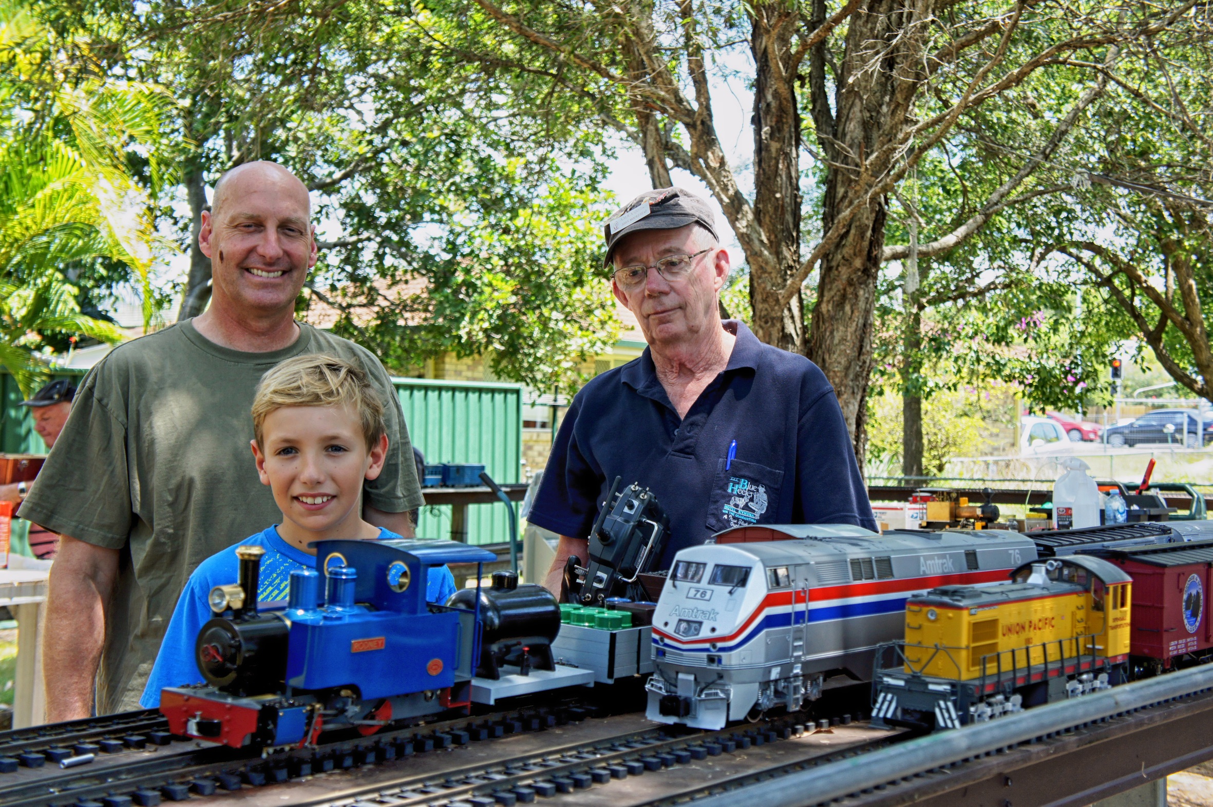 AMRA members Will Monroe, Alex Monroe and John Moorhead operating the garden G scale model trains. AMRA members Will Monroe, Alex Monroe and John Moorhead operating the garden G scale model trains.