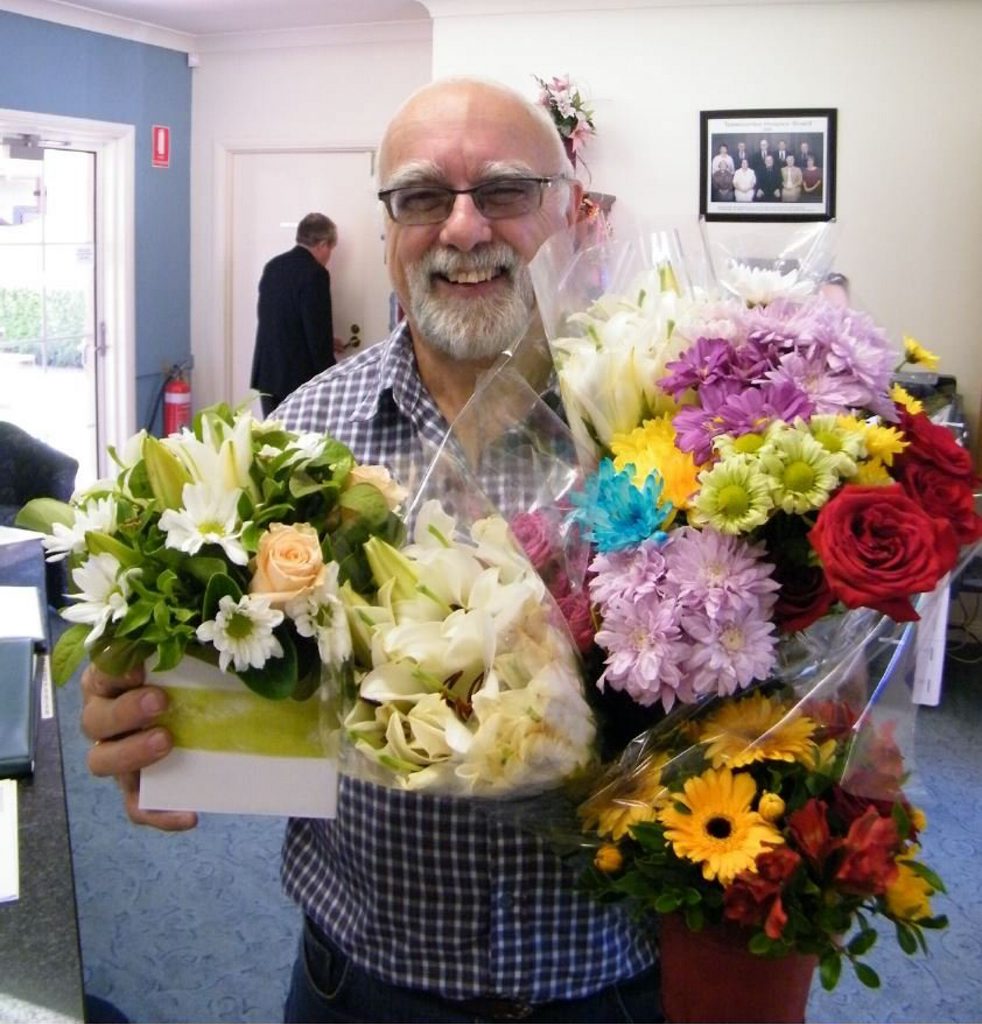 Hospice volunteer courier Wilfred Egert with floral bouquets from Southerden's Florist. The Toowoomba business generously donates flowers to the hospice every Friday. 