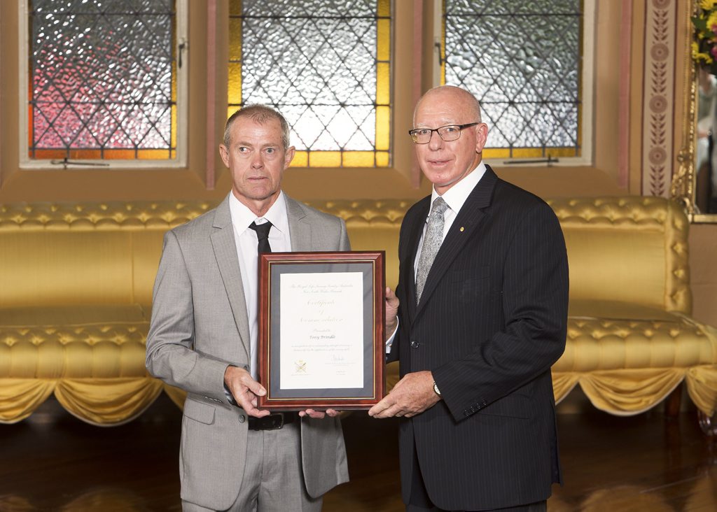 Tony Brindle is presented with his award from the NSW governor. Photo courtesy of Rob Tuckwell Photography Tony Brindle is presented with his award from the NSW governor. Photo courtesy of Rob Tuckwell Photography