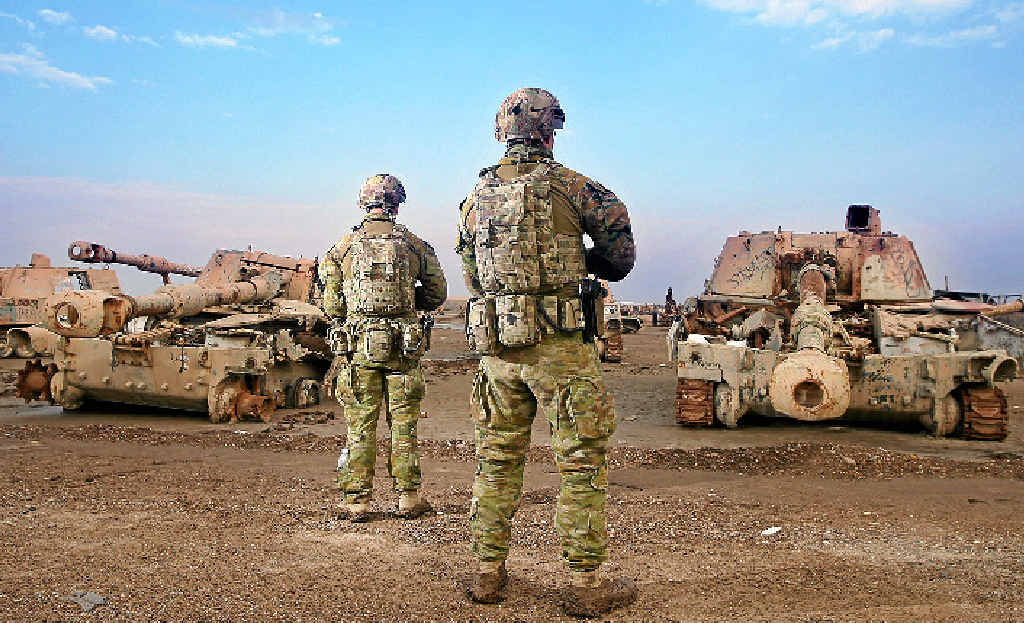 TAKING CARE: Diggers Brandon James, from Mooroopna, Victoria, and Corren Ints, from Morayfield, Queensland, secure a tank graveyard outside an Australian camp in Iraq earlier this year. TAKING CARE: Diggers Brandon James, from Mooroopna, Victoria, and Corren Ints, from Morayfield, Queensland, secure a tank graveyard outside an Australian camp in Iraq earlier this year.
