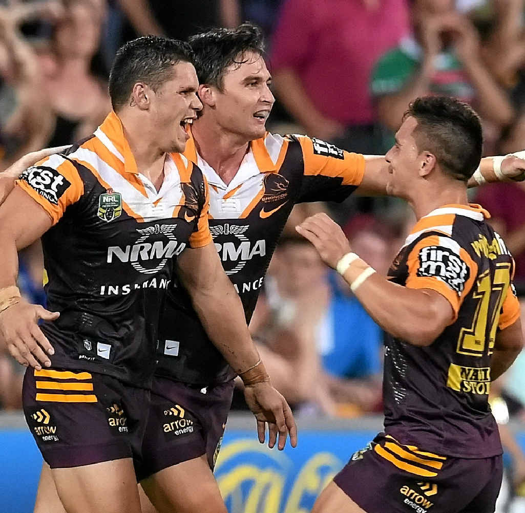 ON TOP: James Roberts celebrates with Broncos teammates after scoring a try at Suncorp Stadium last night. ON TOP: James Roberts celebrates with Broncos teammates after scoring a try at Suncorp Stadium last night.