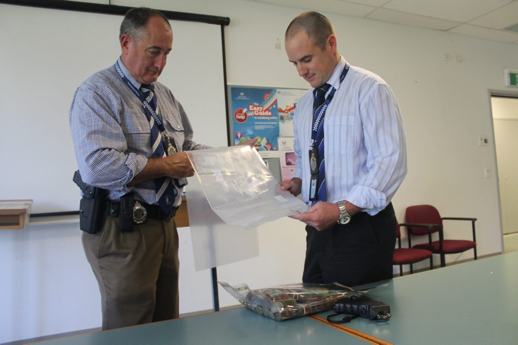 Detective Acting Inspector David Tucker and Detective Acting Senior Sergeant Brett Jackson with roughly 10 grams of methylamphetamine, $56,000 in cash and a taser. Detective Acting Inspector David Tucker and Detective Acting Senior Sergeant Brett Jackson with roughly 10 grams of methylamphetamine, $56,000 in cash and a taser.