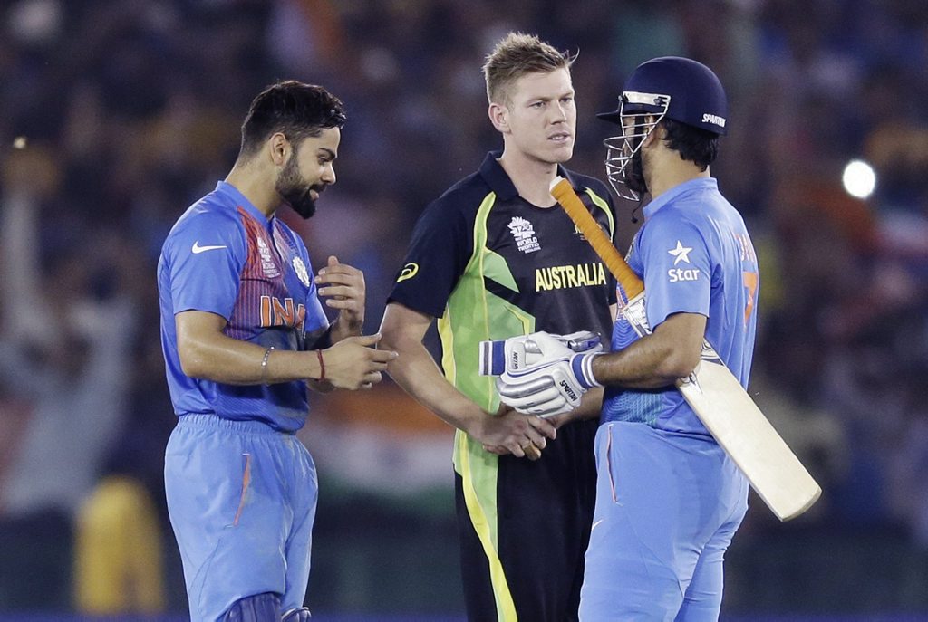 India's Virat Kohli, left, and teammate MS Dhoni, right, are congratulated by Australia's James Faulkner after winning their ICC World Twenty20 2016 cricket match by six wickets in Mohali, India, Sunday, March 27, 2016. (AP Photo/Altaf Qadri) India's Virat Kohli, left, and teammate MS Dhoni, right, are congratulated by Australia's James Faulkner after winning their ICC World Twenty20 2016 cricket match by six wickets in Mohali, India, Sunday, March 27, 2016. (AP Photo/Altaf Qadri)