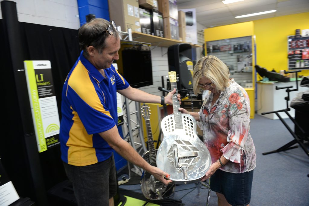 MEMORIES: Gavin Hunter presents Robyn Dixon with her father's 78-year-old guitar, now restored. MEMORIES: Gavin Hunter presents Robyn Dixon with her father's 78-year-old guitar, now restored.