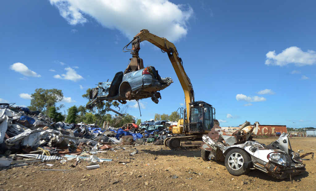 OWNER: Rockhampton Metal Recyclers owner Matthew Moller moves a crushed car using an excavator with a grappling claw. OWNER: Rockhampton Metal Recyclers owner Matthew Moller moves a crushed car using an excavator with a grappling claw.
