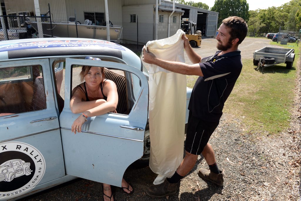 GAME ON: Koryn Turnbull and Matthew Hardgrave with their car that they plan to take on the Shitbox Rally in May. Photo: Max Fleet / NewsMail GAME ON: Koryn Turnbull and Matthew Hardgrave with their car that they plan to take on the Shitbox Rally in May. Photo: Max Fleet / NewsMail