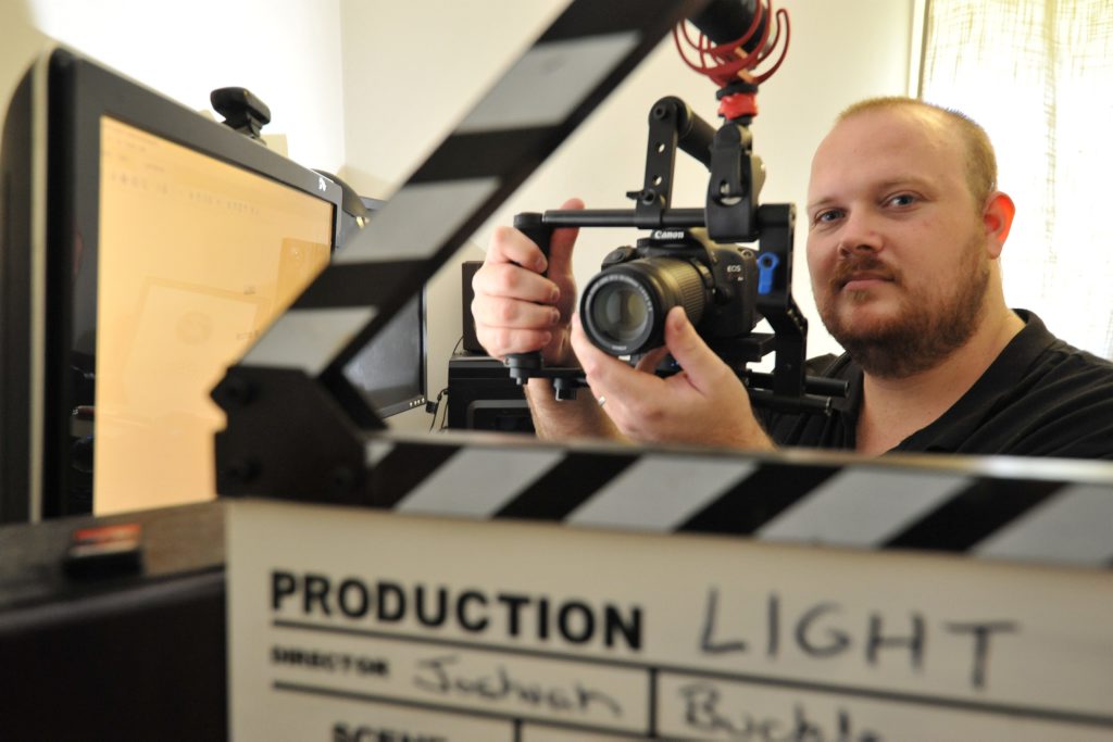 Filmmaker Joshuah Buckle working on a production called Filmmaker Joshuah Buckle working on a production called