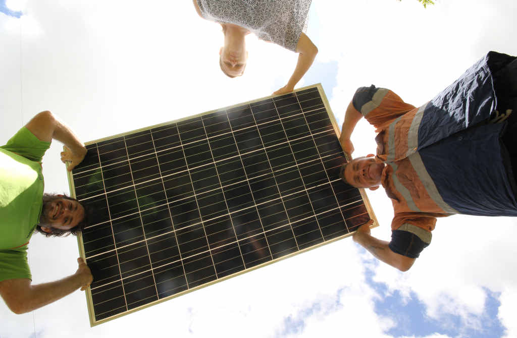 Kon Flaherty with Sharron and William Pratt holding one of the 192,000 solar panels that could soon be installed at Kelsey Creek outside Proserpine. Kon Flaherty with Sharron and William Pratt holding one of the 192,000 solar panels that could soon be installed at Kelsey Creek outside Proserpine.