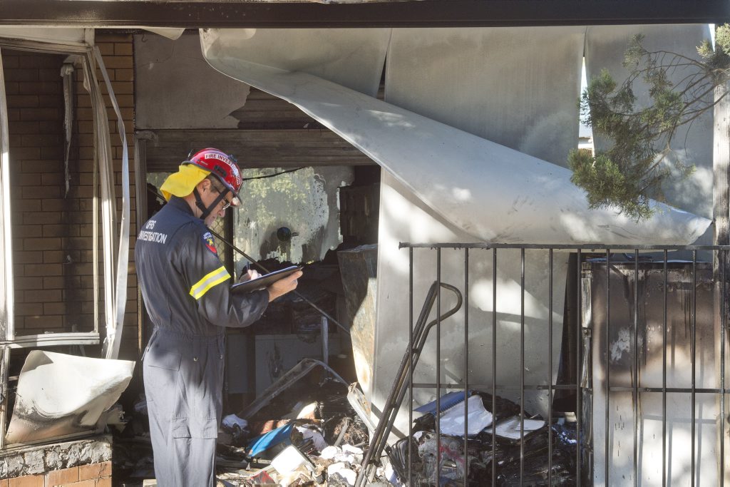 QFES Fire Investigator Peter McCarron at the scene of a house fire at Herries St. QFES Fire Investigator Peter McCarron at the scene of a house fire at Herries St.
