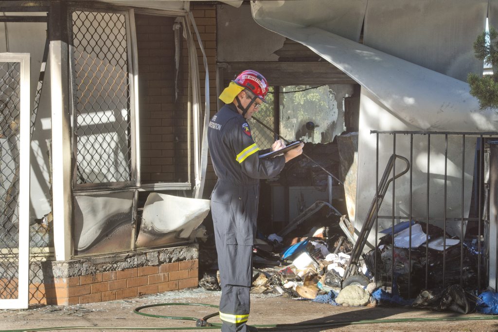 QFES Fire Investigator Peter McCarron at the scene of a house fire at Herries st. QFES Fire Investigator Peter McCarron at the scene of a house fire at Herries st.