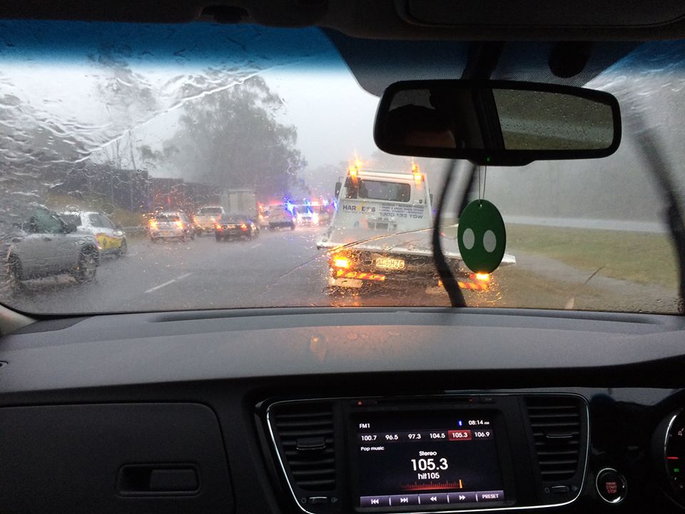 A motorist waits for the crash wreckage to be cleared from the highway. A motorist waits for the crash wreckage to be cleared from the highway.
