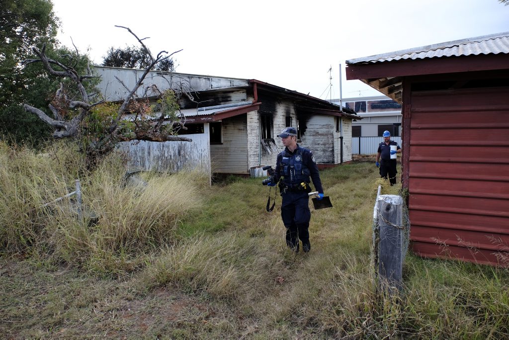 Constable Stuart Smith and a Dalby Scenes of Crime officer leave the burned-out home this morning. Constable Stuart Smith and a Dalby Scenes of Crime officer leave the burned-out home this morning.