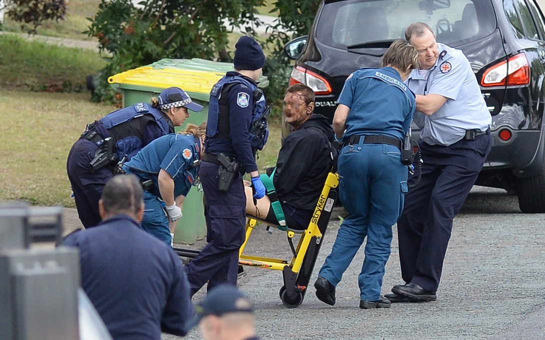 The man (pictured) was taken out of the unit by paramedics and police. The man (pictured) was taken out of the unit by paramedics and police.