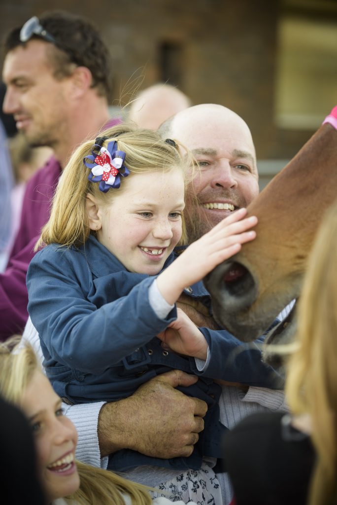 Part owner of Nautile Gary Powell lifts his daughter Amber up to give his Maclean Cup winner Nautile. Photo Adam Hourigan / The Daily Examiner Part owner of Nautile Gary Powell lifts his daughter Amber up to give his Maclean Cup winner Nautile. Photo Adam Hourigan / The Daily Examiner