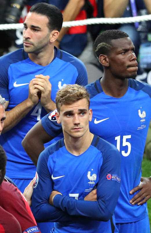 France's Antoine Griezmann, Blaise Matuidi and Adil Rami pause after losing the Euro 2016 final soccer match between Portugal and France at the Stade de France in Saint-Denis, north of Paris, Sunday, July 10, 2016. France's Antoine Griezmann, Blaise Matuidi and Adil Rami pause after losing the Euro 2016 final soccer match between Portugal and France at the Stade de France in Saint-Denis, north of Paris, Sunday, July 10, 2016.