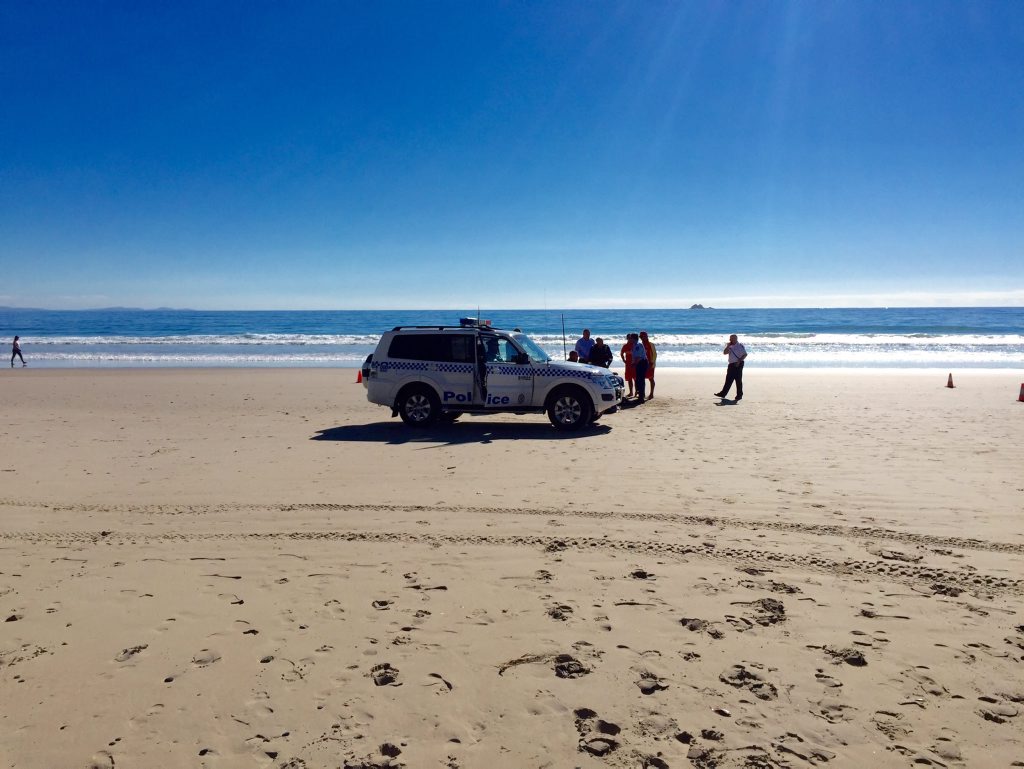 Emergency services working on patient on a Byron Bay beach. Emergency services working on patient on a Byron Bay beach.