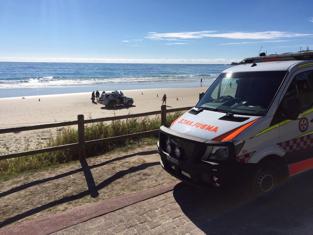 Emergency services working on patient on a Byron Bay beach. Emergency services working on patient on a Byron Bay beach.