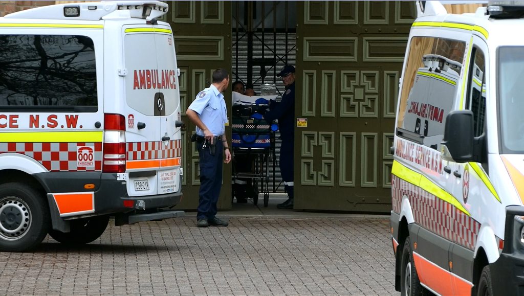 Ambulance officers transporting patients to hospital after a fire yesterday at Grafton Jail. photo: tim howard Ambulance officers transporting patients to hospital after a fire yesterday at Grafton Jail. photo: tim howard