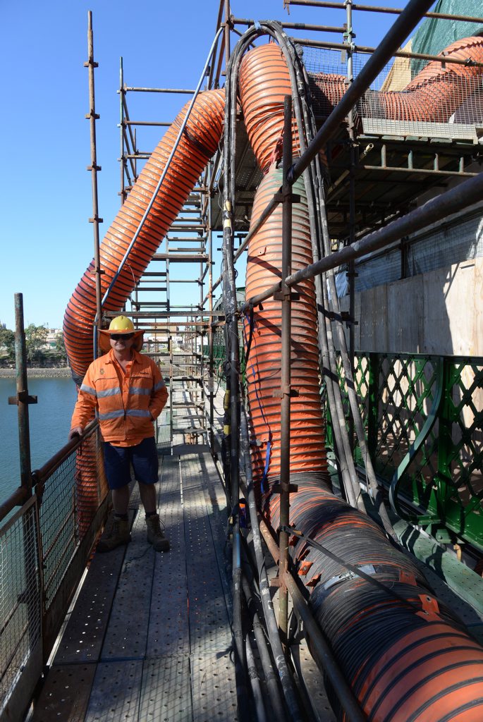 FRESH COAT: Supervisor Tony Cloke on the Burnett Traffic Bridge during the repairs and restoration of the bridge which was the longest steel traffic bridge in Australia on completion in August 1900.