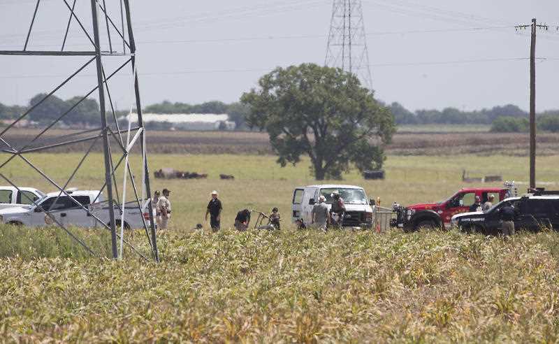Investigators surround the scene in a field near Lockhart, Texas where a hot air balloon carrying at least 16 people collided with power lines Saturday, July 30, 2016, causing what authorities described as a Investigators surround the scene in a field near Lockhart, Texas where a hot air balloon carrying at least 16 people collided with power lines Saturday, July 30, 2016, causing what authorities described as a