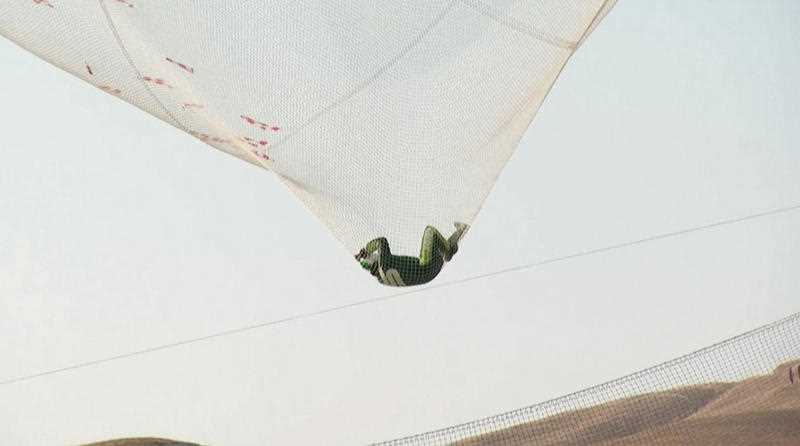 After a two-minute freefall, Aikins landed in the 100-by-100-foot net at the Big Sky movie ranch. After a two-minute freefall, Aikins landed in the 100-by-100-foot net at the Big Sky movie ranch.