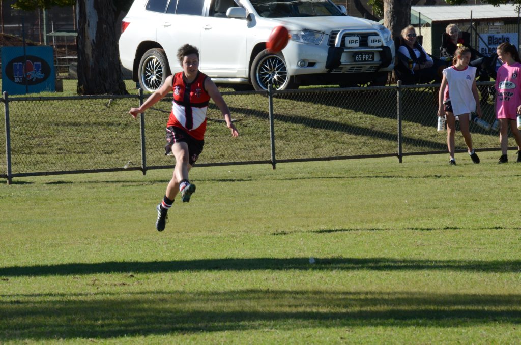 Janille Pasfield kicks down field for the Saints. Saturday July 30, 2016.