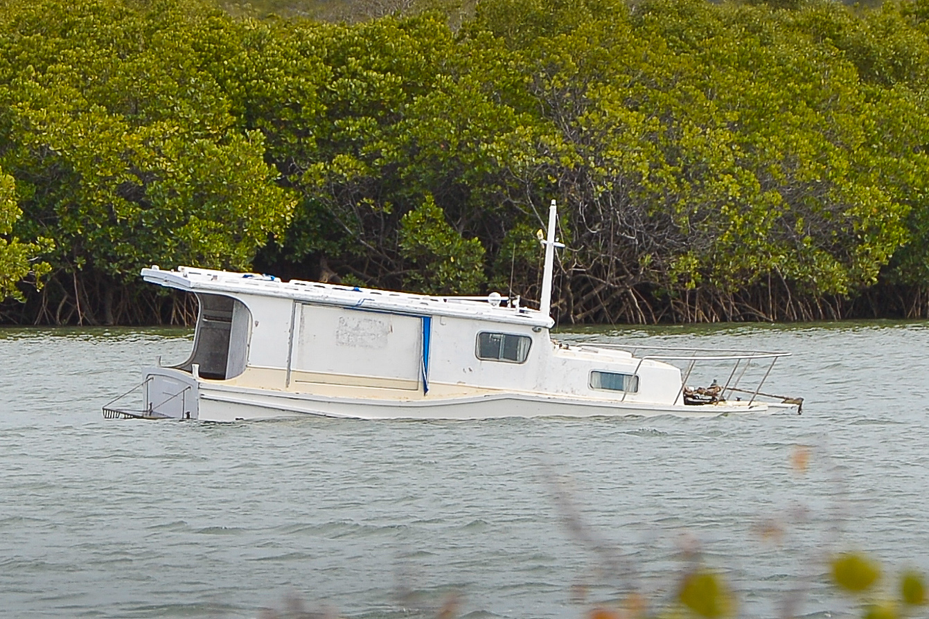 Police search for owner of this boat sinking in the Calliope River. Police search for owner of this boat sinking in the Calliope River.