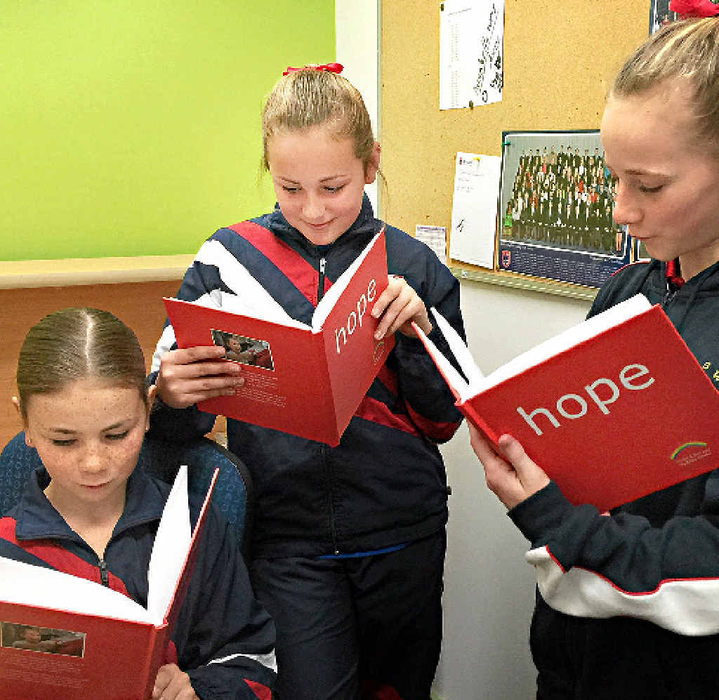 CONNECTION: Billie Kinder’s schoolmates at Arndell Anglican College check out their copies of Hope. Photo: Anna McPherson CONNECTION: Billie Kinder’s schoolmates at Arndell Anglican College check out their copies of Hope. Photo: Anna McPherson
