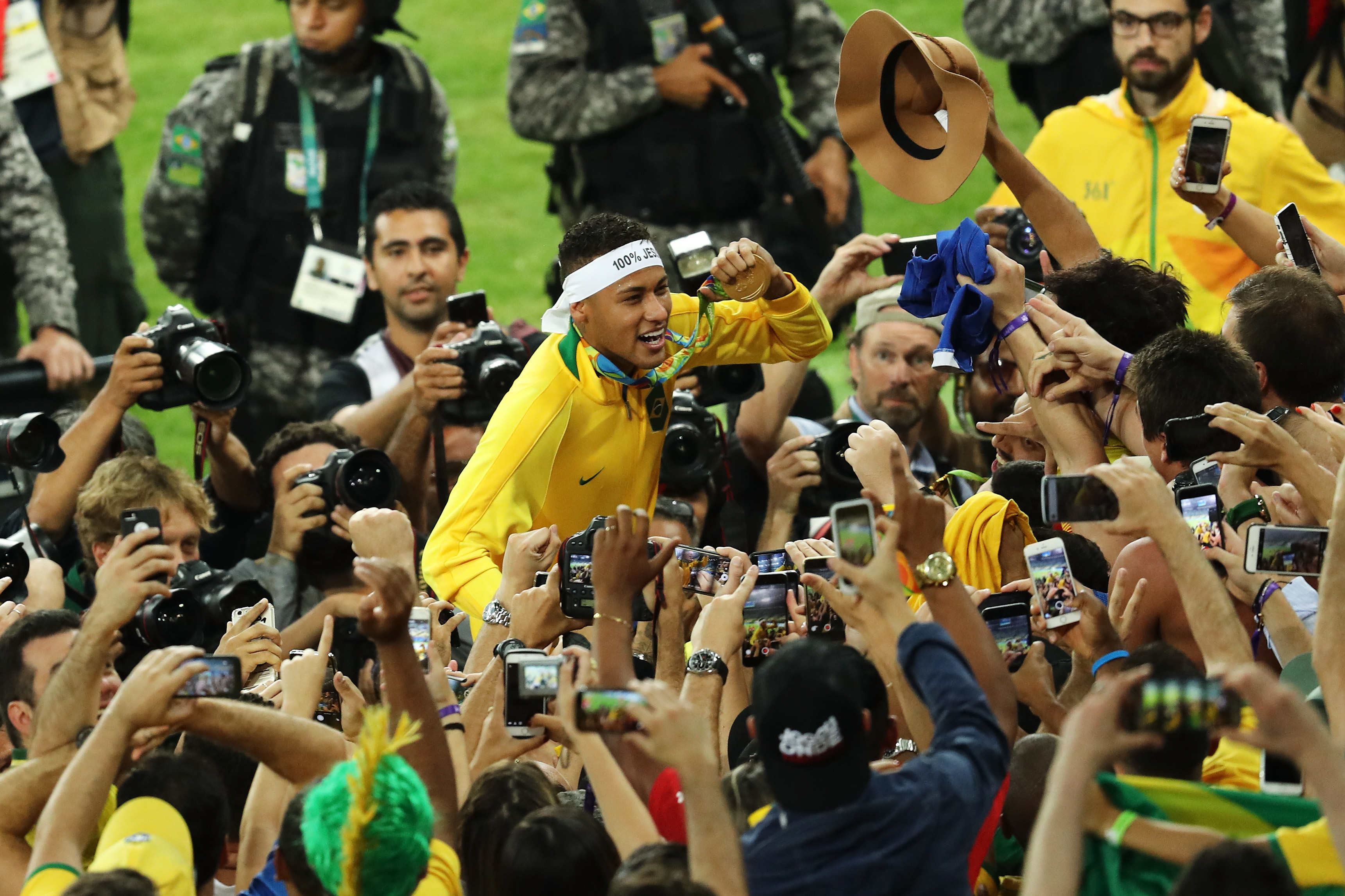 Neymar is swamped by media and fan after clinching the gold medal for his country. Neymar is swamped by media and fan after clinching the gold medal for his country.