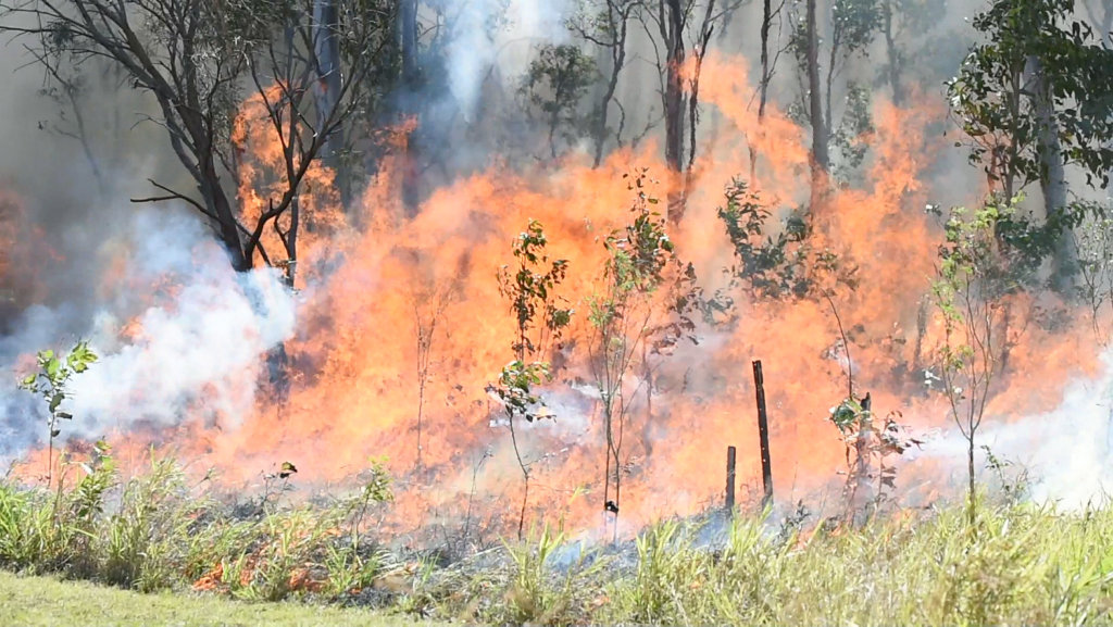 Bushfire in scrub at the end of Searle St in Maryborough. Firefighters backburn long grass behind the Ergon depot to contain the fire. Bushfire in scrub at the end of Searle St in Maryborough. Firefighters backburn long grass behind the Ergon depot to contain the fire.