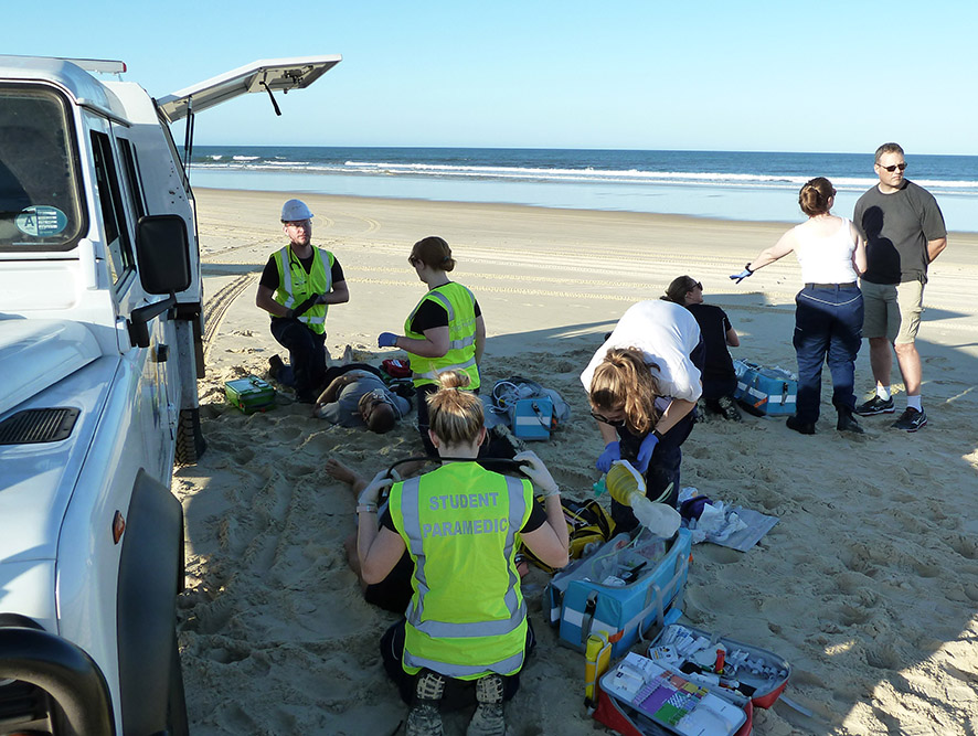 Students get up close and personal with their 'bodies' during a crash scenario on Fraser Island as part of training. Students get up close and personal with their 'bodies' during a crash scenario on Fraser Island as part of training.