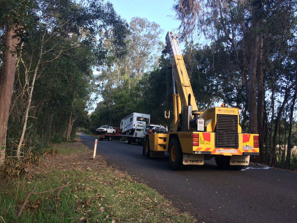 A crane retrieves a car and a caravan from a creek on Teven Rd, Teven. A crane retrieves a car and a caravan from a creek on Teven Rd, Teven.