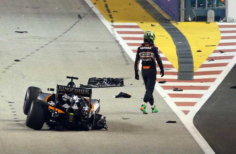 Force India driver Nico Hulkenberg of Germany walks from his car after crashing at the start of the Singapore Formula One Grand Prix on the Marina Bay City Circuit in Singapore, Sunday, Sept. 18, 2016. Force India driver Nico Hulkenberg of Germany walks from his car after crashing at the start of the Singapore Formula One Grand Prix on the Marina Bay City Circuit in Singapore, Sunday, Sept. 18, 2016.