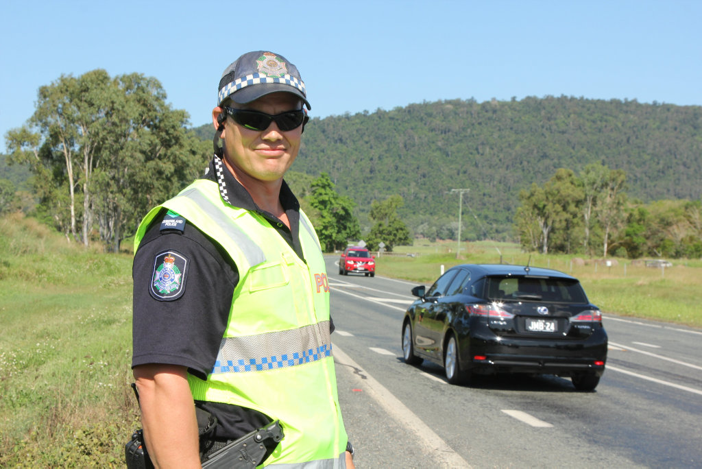 Senior Constable Tim Farran at the scene of a twin vehicle collision on the Bruce Hwy this afternoon.Photo Peter Carruthers / Whitsunday Times