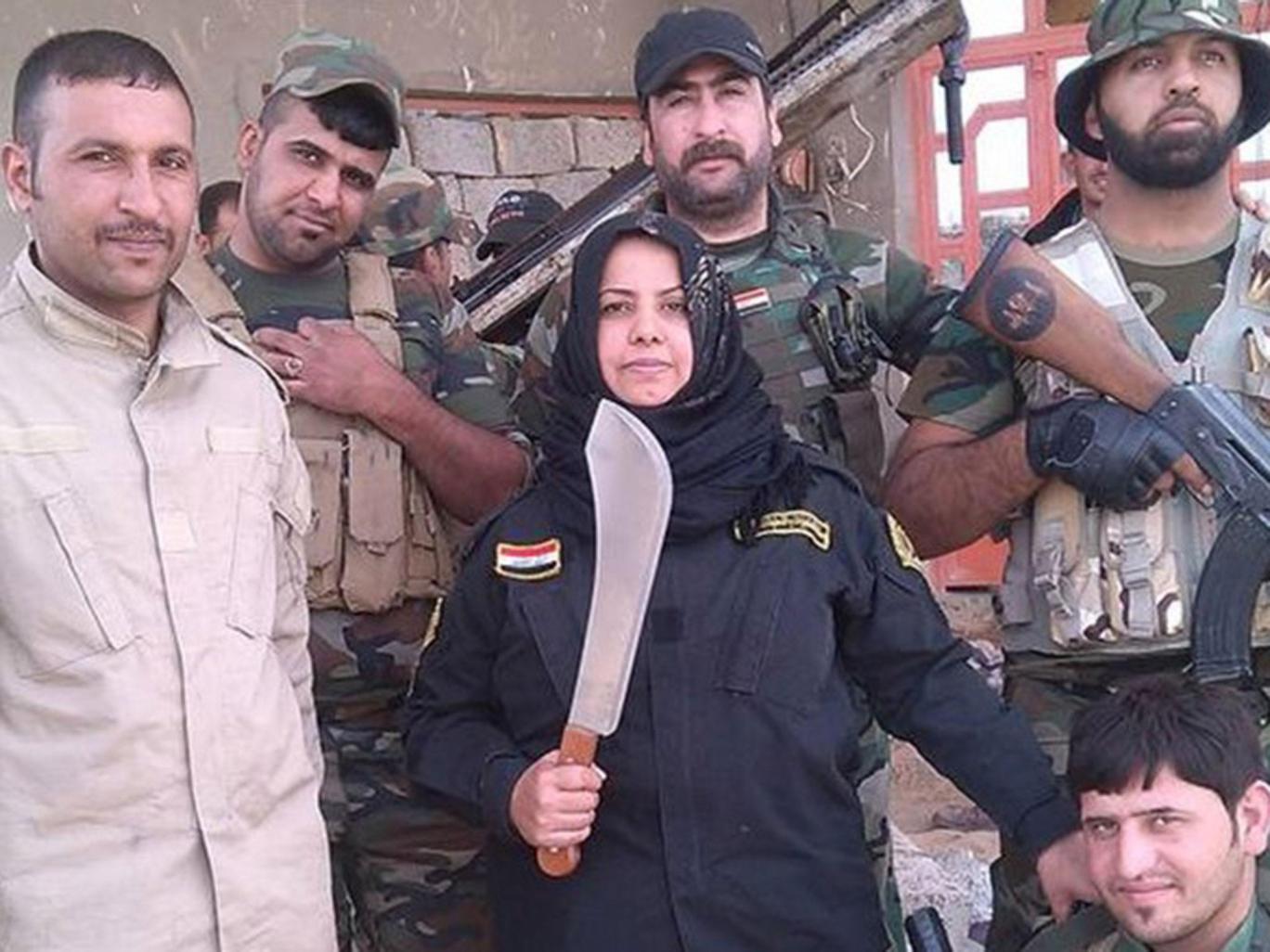 Wahida Mohamed Al-Jumaily, 39, published a photo on Facebook appearing to show her carrying a severed head, and another showing two severed heads in a cooking pot. Wahida Mohamed Al-Jumaily, 39, published a photo on Facebook appearing to show her carrying a severed head, and another showing two severed heads in a cooking pot.