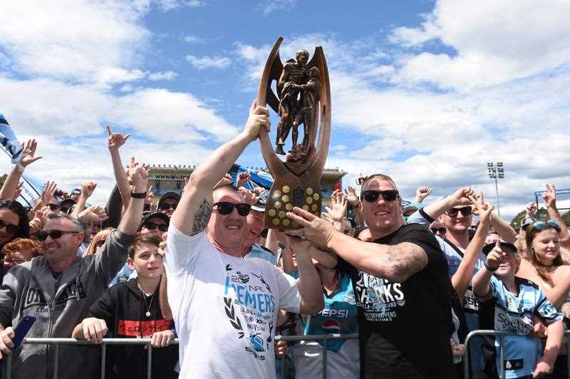 Cronulla Sharks captain Paul Gallen and forward Luke Lewis hold up the trophy at a fan day at Southern Cross Group Stadium, after they defeated the Melbourne Storm in the 2016 NRL Grand Final in Sydney, Monday, Oct. 3, 2016. Cronulla Sharks captain Paul Gallen and forward Luke Lewis hold up the trophy at a fan day at Southern Cross Group Stadium, after they defeated the Melbourne Storm in the 2016 NRL Grand Final in Sydney, Monday, Oct. 3, 2016.
