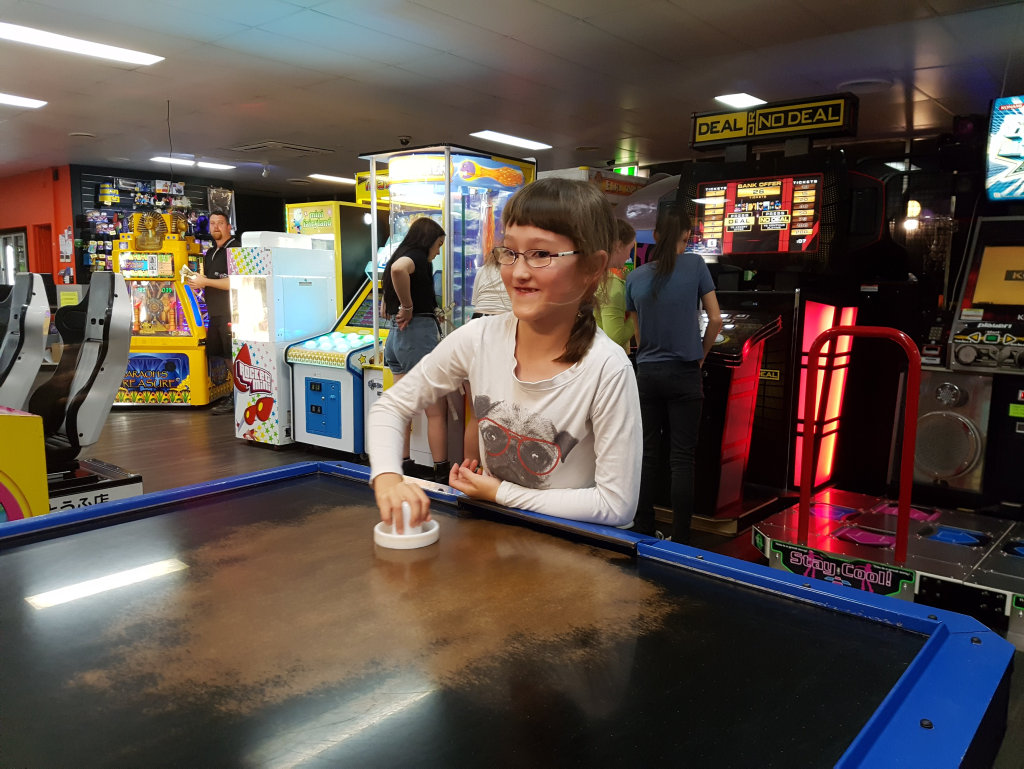 Sarah Wilson plays airhockey at Bazinga Entertainment Centre. Photo Contributed