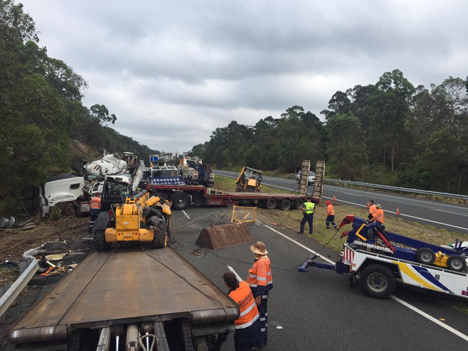 'It's a bit of a mess': Tow truck drivers work to clear the wreckage of a semi-trailer that has blocked the Bruce Hwy near Nambour. 'It's a bit of a mess': Tow truck drivers work to clear the wreckage of a semi-trailer that has blocked the Bruce Hwy near Nambour.