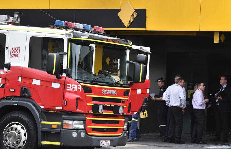 Emergency service workers are seen at the Commonwealth Bank in Springvale in Melbourne, Friday, Nov. 18, 2016. Emergency service workers are seen at the Commonwealth Bank in Springvale in Melbourne, Friday, Nov. 18, 2016.