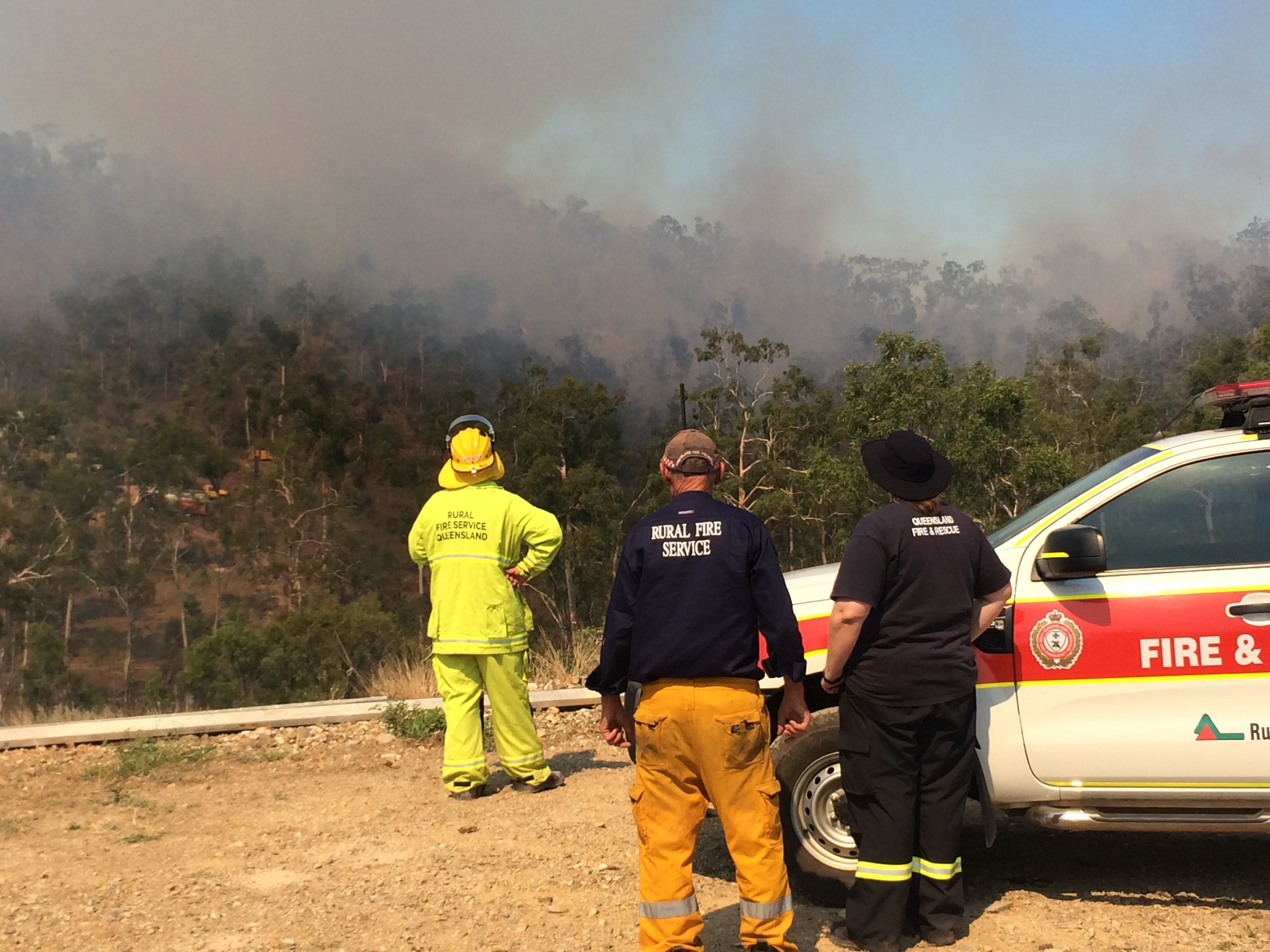 Fire crews coordinate aircraft flying over fire. Fire crews coordinate aircraft flying over fire.