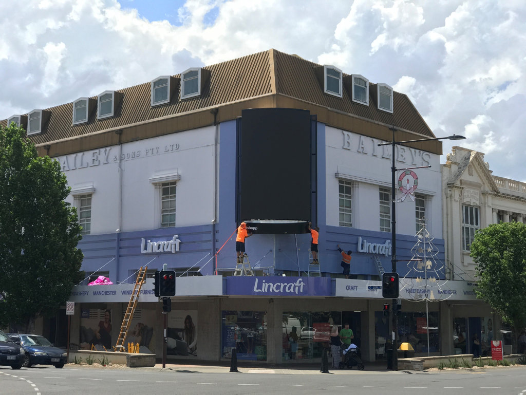 GOING UP: Workers erect the new billboard in the Toowoomba CBD.
GOING UP: Workers erect the new billboard in the Toowoomba CBD.