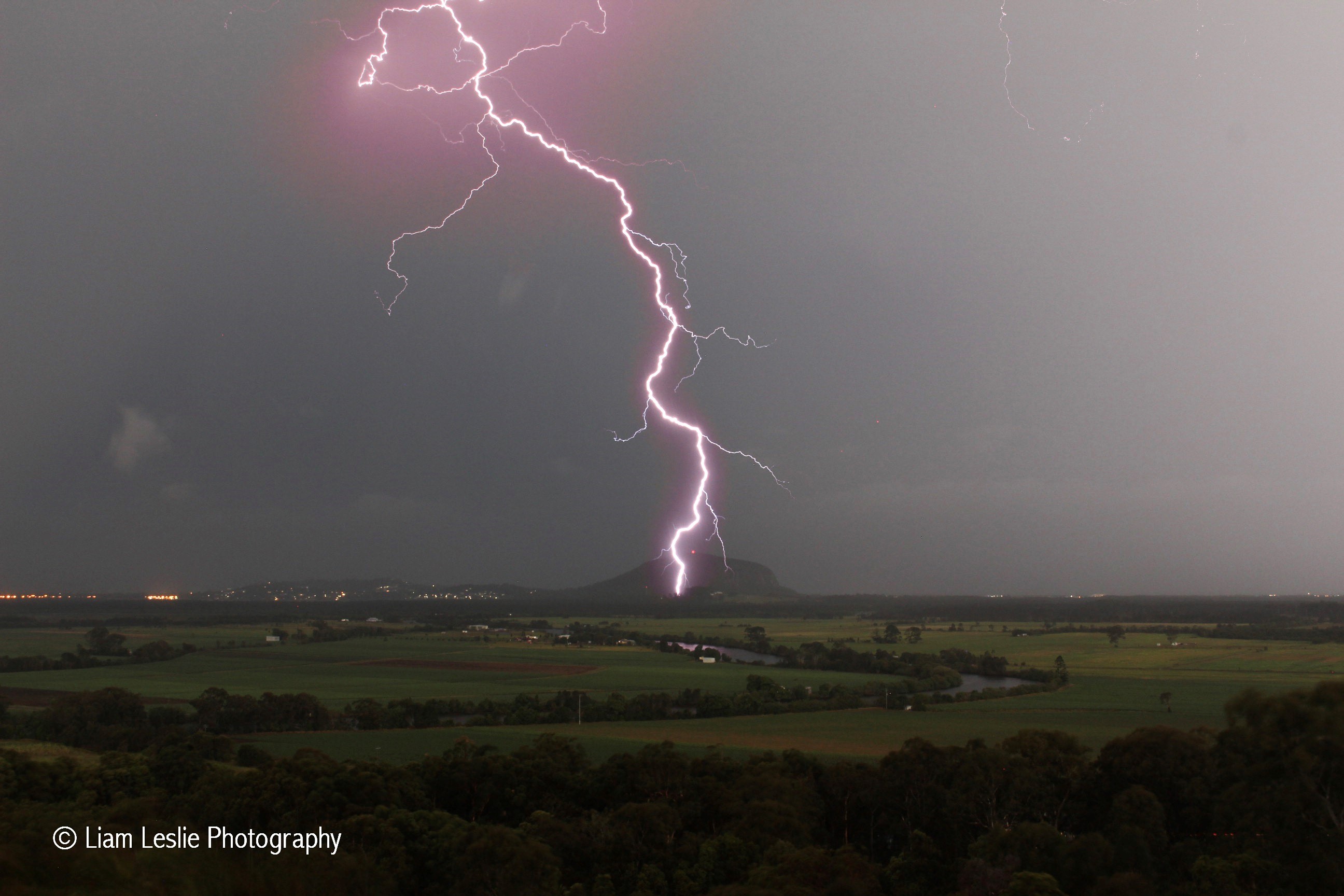 Lightning strikes in front of Mount Coolum. Lightning strikes in front of Mount Coolum.