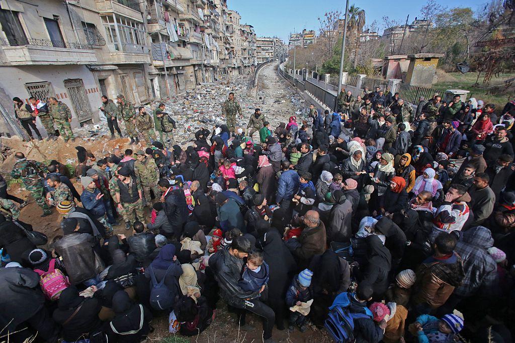East Aleppo residents flee the violence at a checkpoint manned by pro-government forces in Maysaloun, Aleppo, on December 8 2016 AFP East Aleppo residents flee the violence at a checkpoint manned by pro-government forces in Maysaloun, Aleppo, on December 8 2016 AFP