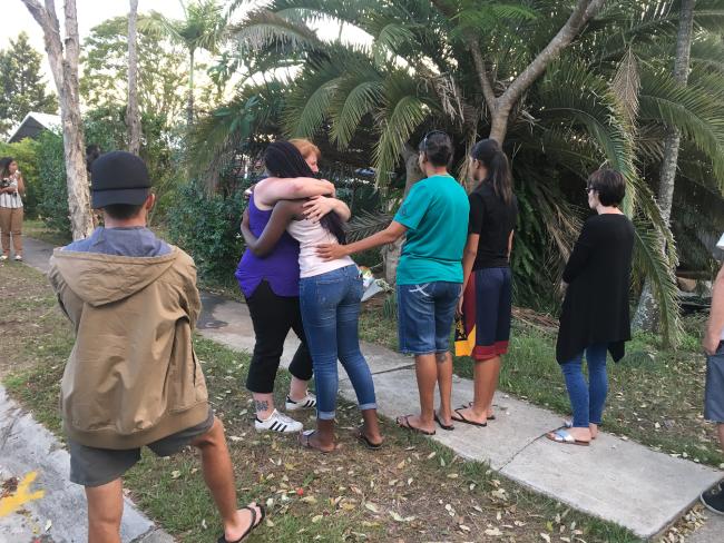 Friends of the accused driver console mourners for Josiah Sisson, 9, in Springwood this evening. Pic: Madura McCormack Friends of the accused driver console mourners for Josiah Sisson, 9, in Springwood this evening. Pic: Madura McCormack