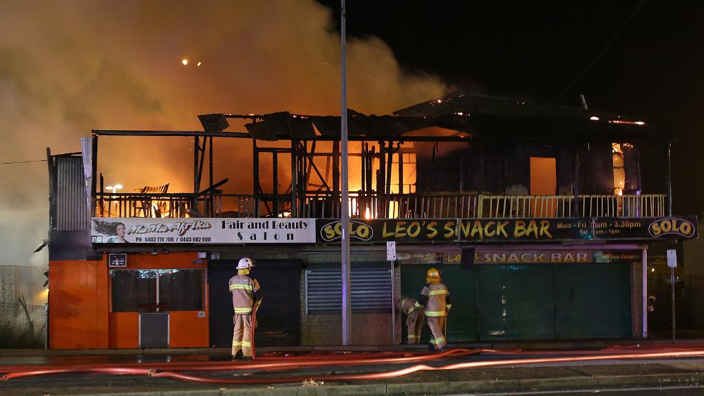 Firefighters at the scene of a huge blaze at a business on the Magic Mile at Moorooka. PIC: Marc Robertson. Firefighters at the scene of a huge blaze at a business on the Magic Mile at Moorooka. PIC: Marc Robertson.