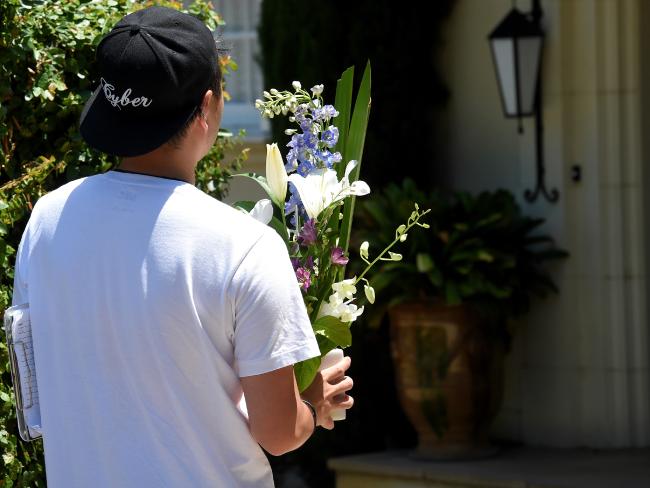 A courier delivers flowers to the Hird family home on Friday. A courier delivers flowers to the Hird family home on Friday.