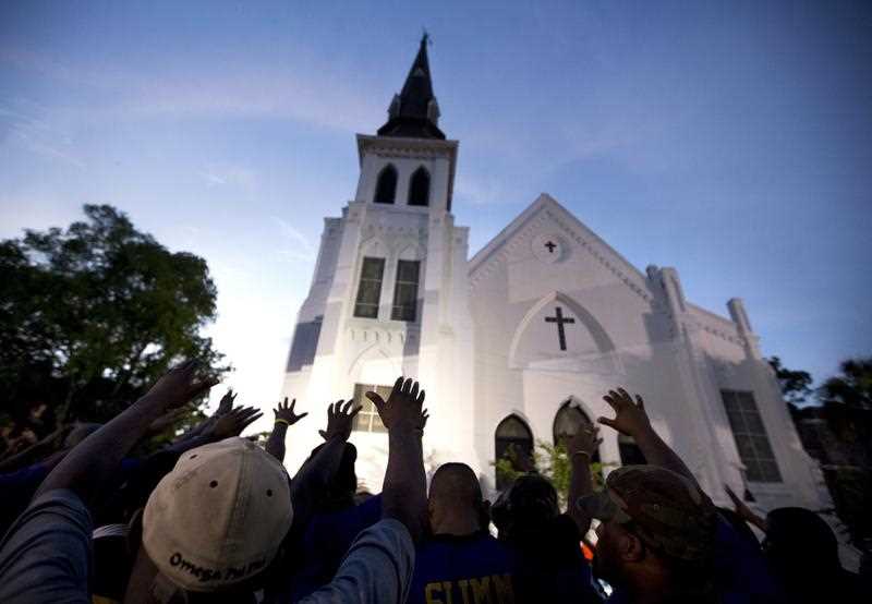 A crowd of people in prayer outside the Emanuel AME Church, after a memorial for the nine people killed by Dylann Roof in Charleston, S.C. A federal jury will consider whether Roof should be sentenced to death or life in prison for the racially motivated attack